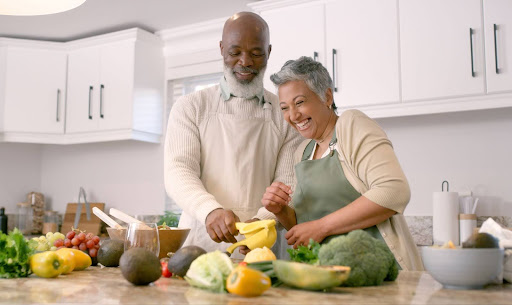 senior couple making meal in kitchen; benefits of fiber