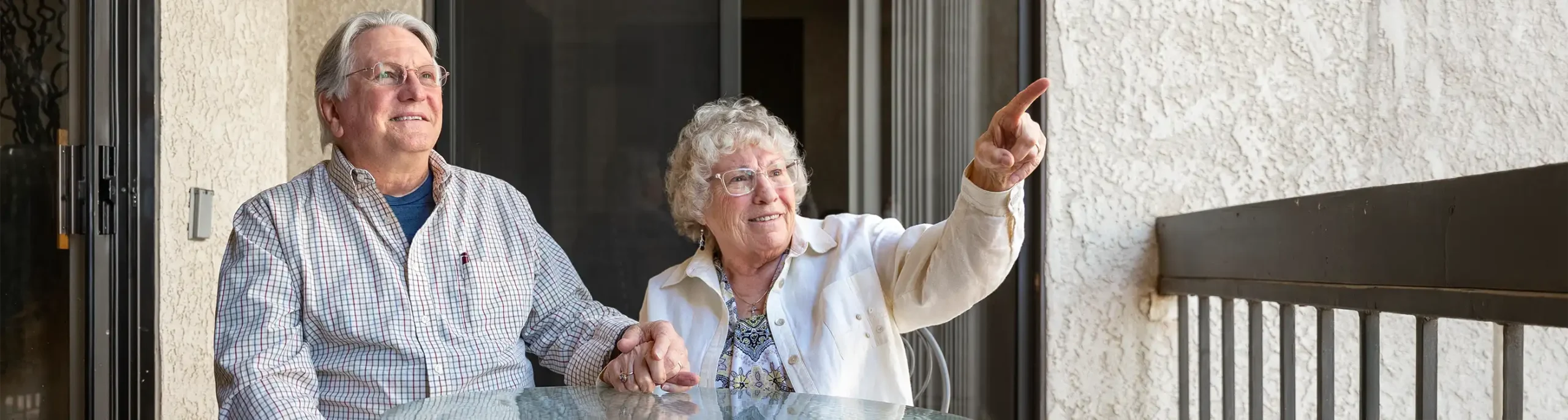 foundation page image, couple sitting on balcony