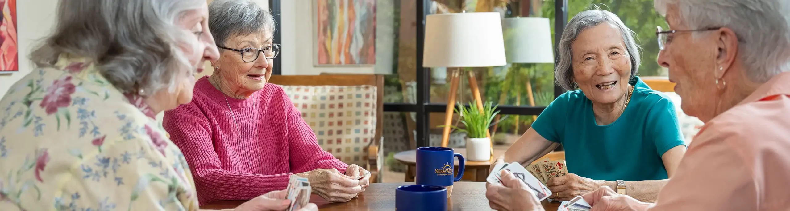 About Sierra Winds Senior Living health care - seniors playing cards at a table
